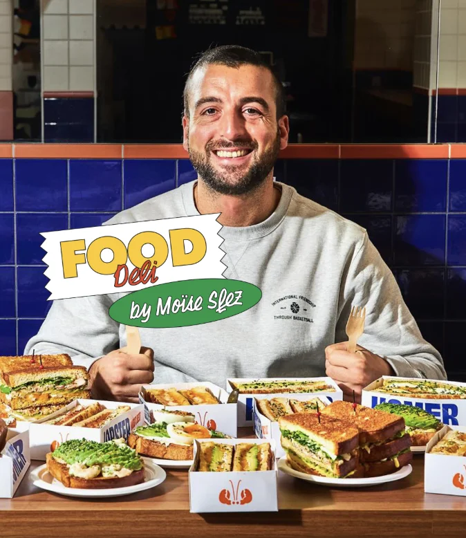Moïse Sfez behind the Food Deli menu he created for the bodega